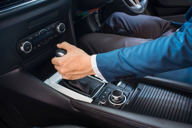 istock driving car closeup hand on gear ,modern car 1145554566