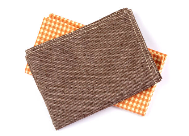 istock crumpled orange brown checkered napkin table clothes  on white background. 1145561332