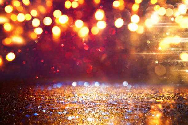 istock glitter vintage lights background. black, gold and red. de-focused 1145568520