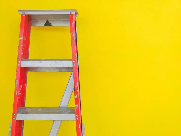 istock Stainless steel stairs on the yellow wall background. 1145568595
