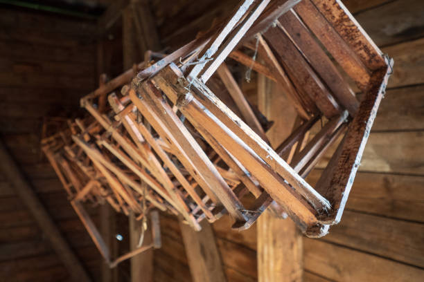 wooden honeycomb frames hanging from the ceiling inside an old log cabin in the salzkammergut region, oö, austria - home interior cabin shack european alps imagens e fotografias de stock