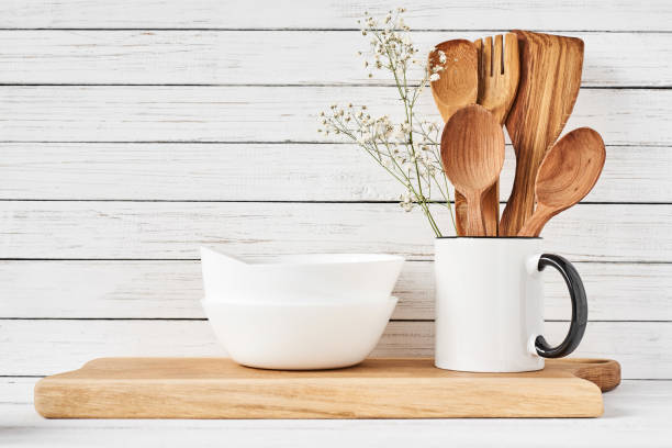 istock Cooking utensils and cutting board on white table 1145573754