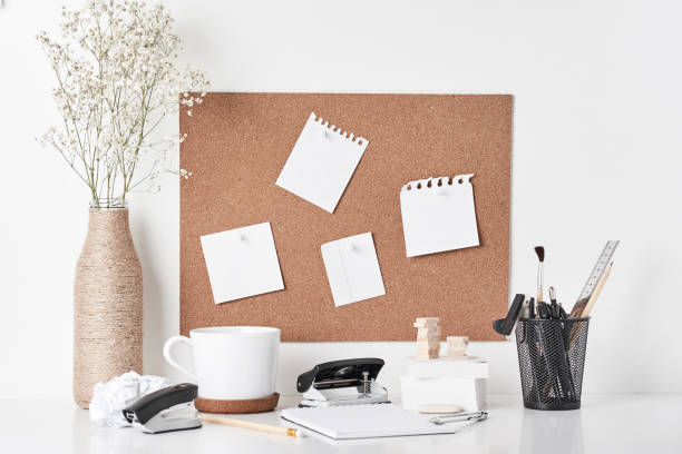 istock Cork board with office supplies on white background 1145573799