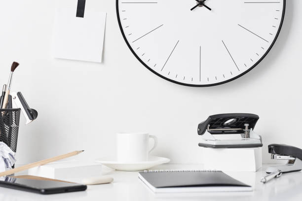 istock Office supplies and wall clock on white 1145573813