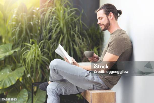 Relaxing Hipster Man Reading A Book Stock Photo - Download Image Now - Men, Reading, Relaxation