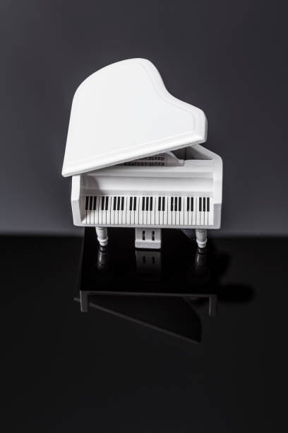 istock White tiny piano music on a black background 1145581885