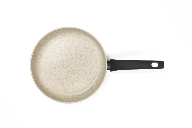 istock Photo of a bright ceramic pan with a black handle, isolated on a white background. Studio shot 1145583555