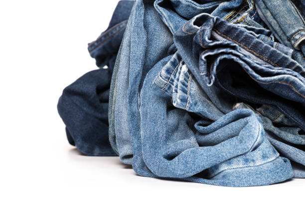 istock stack of various shades of blue jeans on white background 1145584361