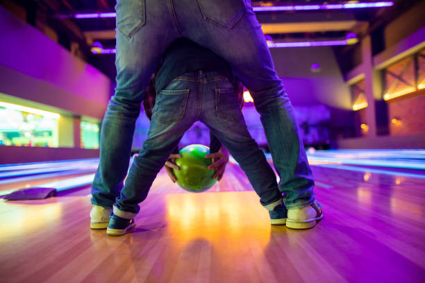 istock Father and son at bowling alley 1145584385