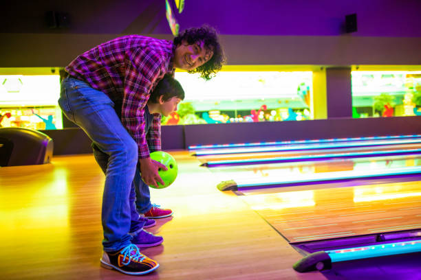 istock Father and son at bowling alley 1145584389