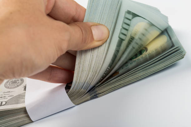 istock woman hand with dollars isolated on a white background 1145584424