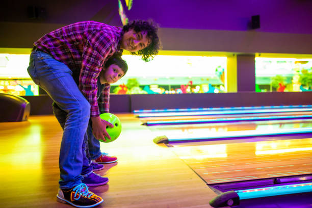 istock Father and son at bowling alley 1145584479