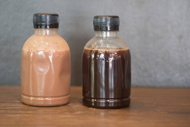 Plastic coffee bottle on wood table - cold brew and mocha