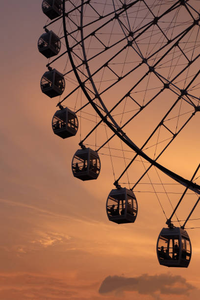 istock close up silhouette of ferris wheel with sunset clouds 1145589877