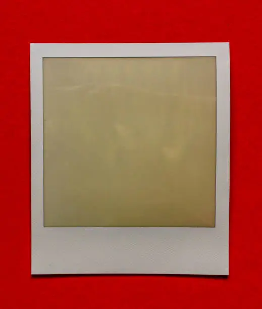 Photo of old empty instant film frame on real paper background