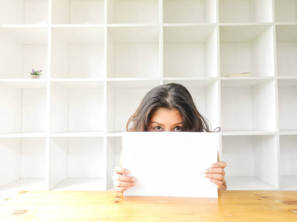 istock Asian woman holding blank white paper 1145596126
