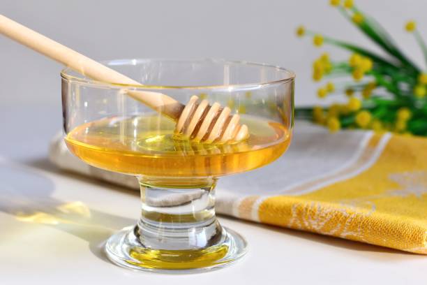istock Close-Up Of Honey Dipper In Container 1145596149