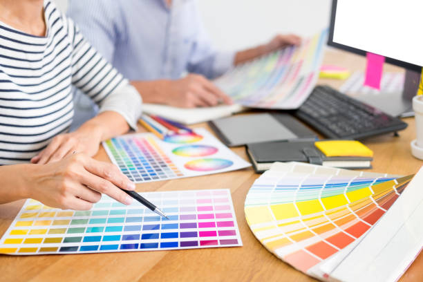 istock Midsection Of Design Professionals Working Over Color Swatches On Table 1145599480