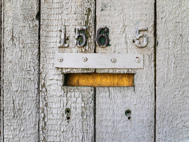 istock Old mailbox on a gray wooden fence 1145600751