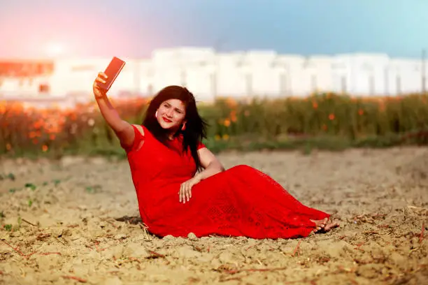 Photo of Indian women taking a Selfie by using smart phone
