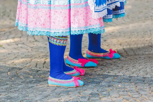 Photo of Woman at the Slovak traditional folklore festival is wearing traditional Eastern Europe folk costumes and footwear