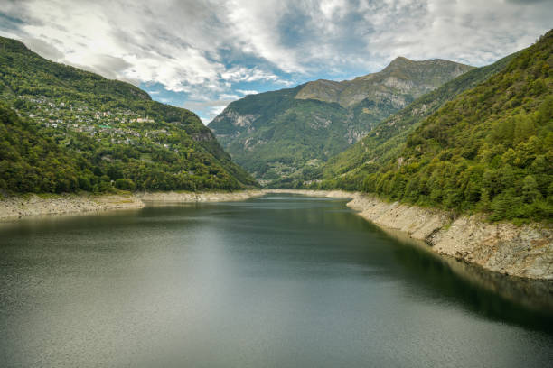 Lago di Vogorno with Swiss Alps in the background in canton of Ticino Lago di Vogorno with Swiss Alps in the background in canton of Ticino, Switzerland vogorno stock pictures, royalty-free photos & images