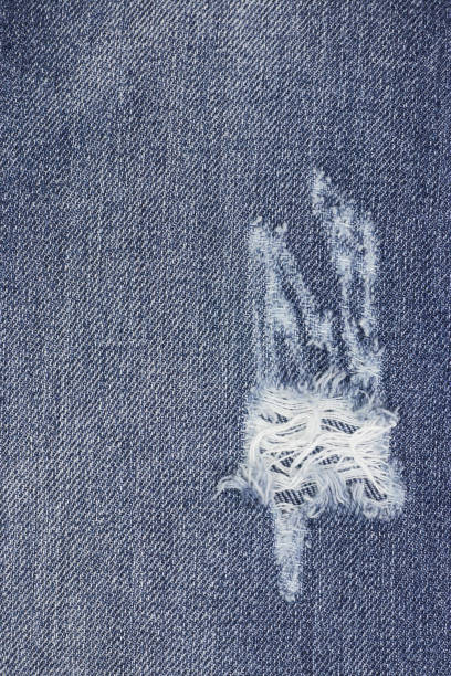 istock Denim ripped blue jeans texture. Abstract background faded jeans. background for design. 1145607778