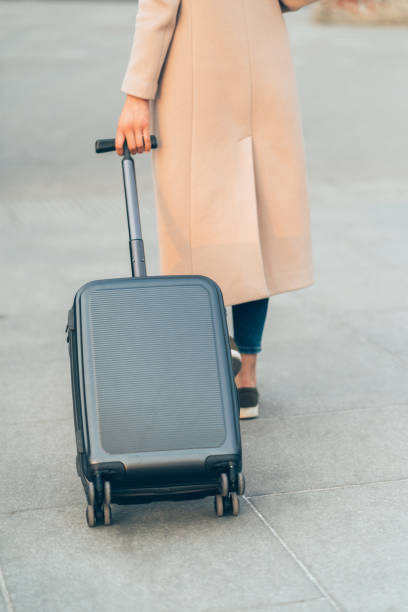 istock Woman walking with suitcase 1145612123