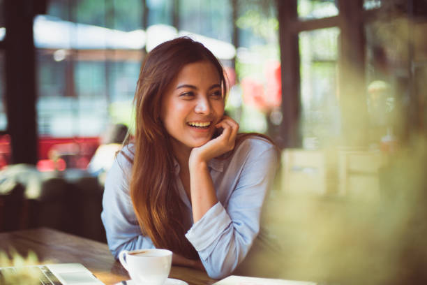 istock Asian woman in cafe drinking coffee 1145613874