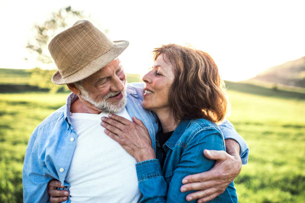 istock Senior couple hugging outside in spring nature. 1145617227