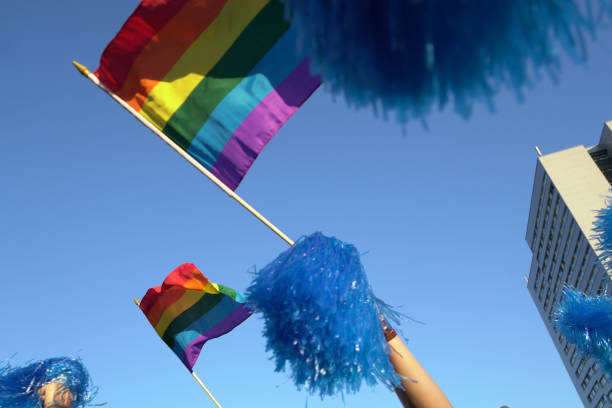 istock LOW ANGLE VIEW OF PRIDE FLAGS WAVING AGAINST CLEAR BLUE SKY 1145618510