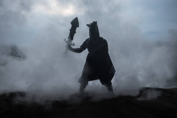 istock Medieval battle scene with cavalry and infantry. Silhouettes of figures as separate objects, fight between warriors on sunset foggy background. Artwork decoration. Selective focus 1145618760