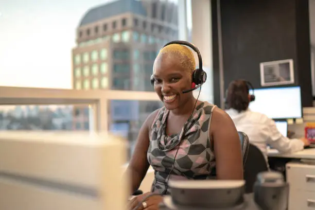 Businesswoman wearing headset in office callcenter