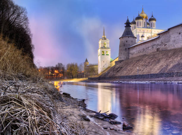 View of the Pskov Kremlin in winter without snow View of the Pskov Kremlin with a reflection in the Pskova River on the eve of the New Year. December view without snow. pskov city stock pictures, royalty-free photos & images