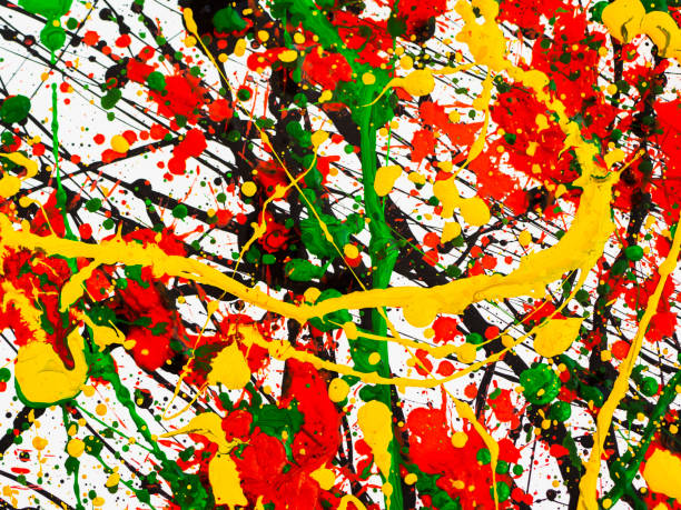 istock splashes on red and black and green and yellow paint 1145619687