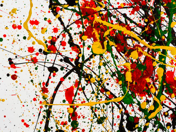 istock splashes on red and black and green and yellow paint 1145619930