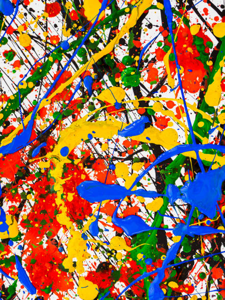 istock splashes on red and black and green and yellow and blue paint 1145620162