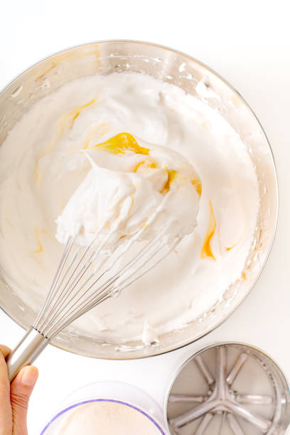 istock Baking bakery concept whipped eggs mix with ingredients for homemade sponge cake on white background 1145621461