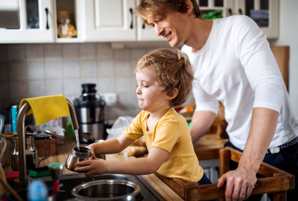 istock A young father with a toddler son in a kitchen at home. 1145624089