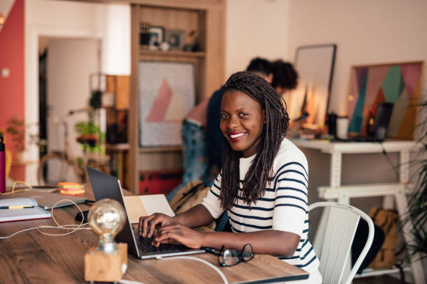 istock Happy African woman working in a modern co-working space 1145624795