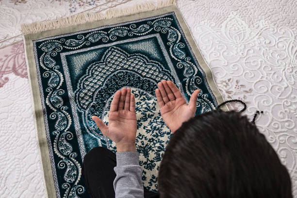 istock a praying muslim prays on both hands, 1145624837