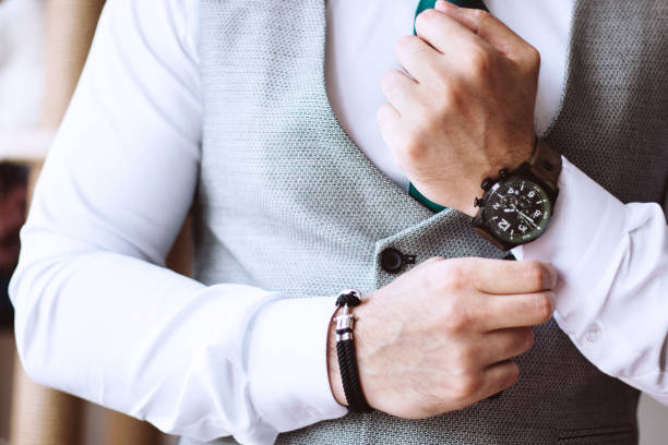 istock Groom fixing cuff links on his shirt 1145627187