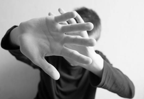 istock Teen boy protects himself with open palm 1145627473