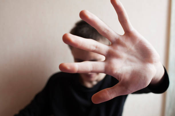 istock Teen boy protects himself with open palm 1145627485