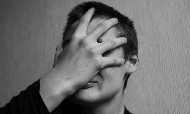 istock Teen boy covers his face with his hands 1145628027