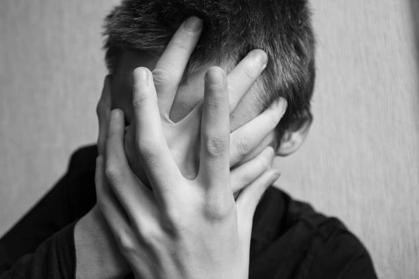 istock Teen boy covers his face with his hands 1145628067