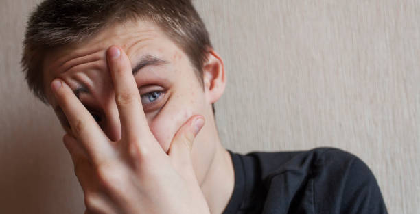 istock Teen boy covers his face with his hands 1145628113