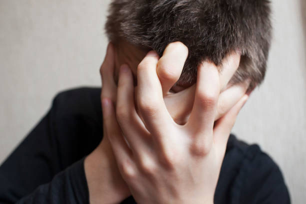 istock Teen boy covers his face with his hands 1145628128