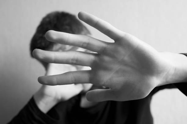 istock Teen boy protects himself with open palm 1145628161