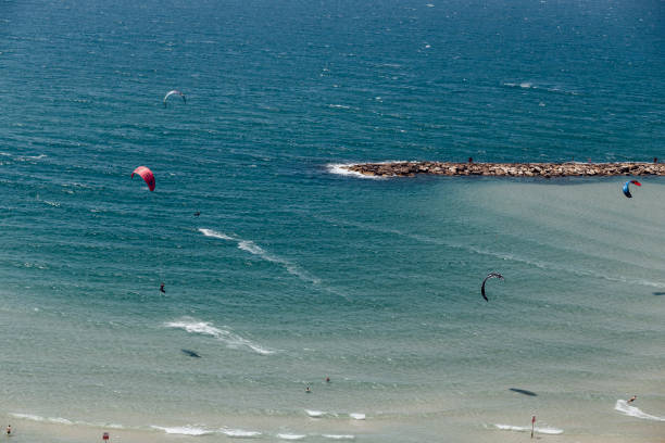 Aerial view of kitesurfer riding on waves at Baltic Sea. Recreation on the Baltic Sea, Tourism in Poland.